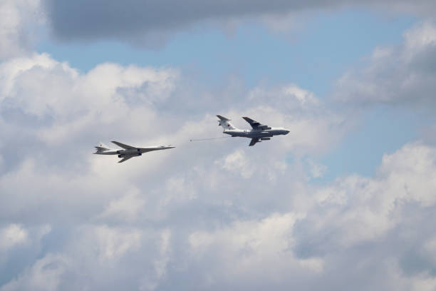 Russian Air Force Tu-160 "White Swan" bomber in flight Moscow, Russia - May 2021: Russian Air Force Tu-160 "White Swan" bomber and air tanker Ilyushin IL-78 perform demonstration flight in the sky during rehearsing of Victory Parade in Moscow tu160 stock pictures, royalty-free photos & images