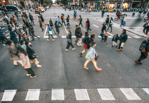 People wearing masks walking on zebra crossing People wearing masks walking on zebra crossing covid crowd stock pictures, royalty-free photos & images