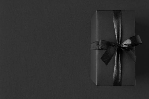 istock Black Gift box close up on dark background 1316434784