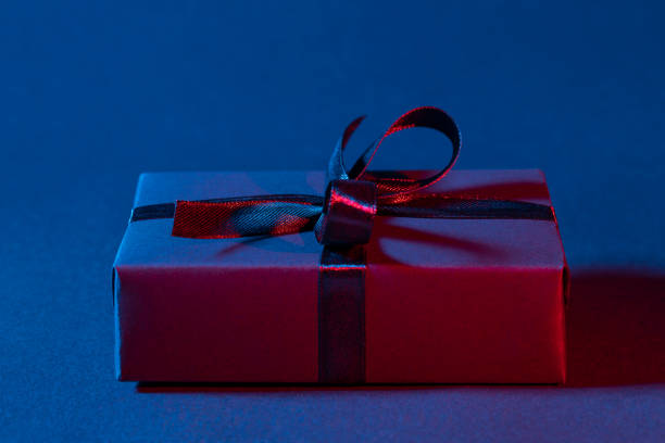 istock Blue red gift box close up on dark background 1316434856