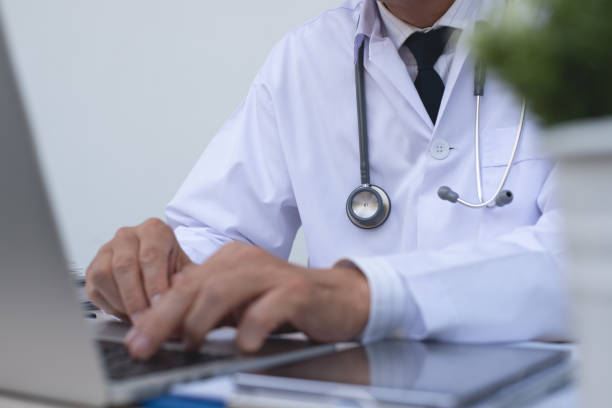 istock Doctor working on laptop computer in medical office 1316437354