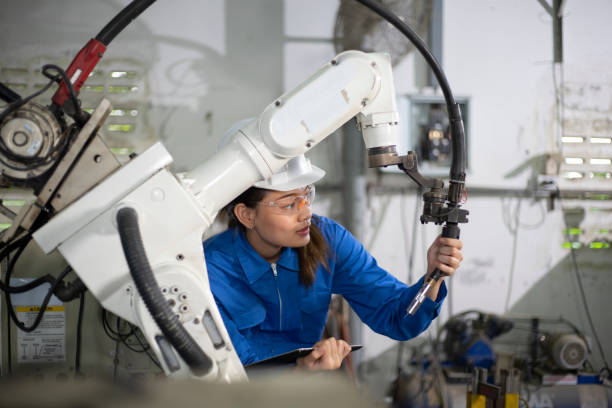 istock Woman mechanic repairing a robot machine. 1316437700