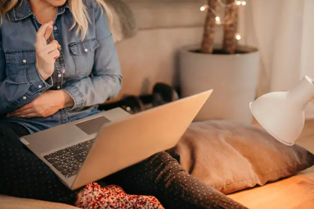 Photo of Woman crossing fingers while sitting with laptop