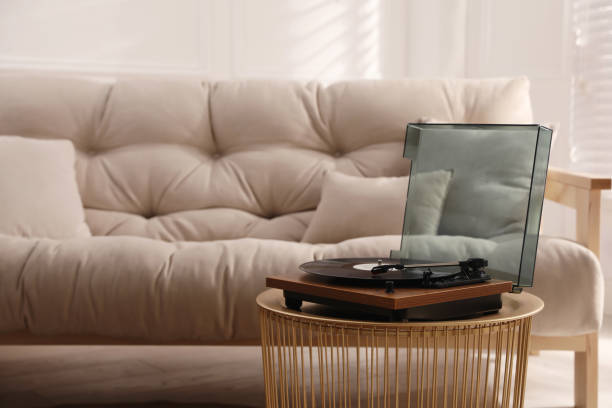 istock Stylish turntable with vinyl disc in living room 1316440387