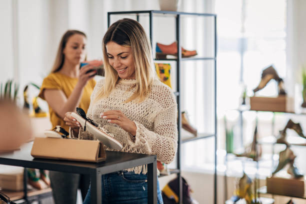 women in fashion store - shoe store shoe shopping retail imagens e fotografias de stock