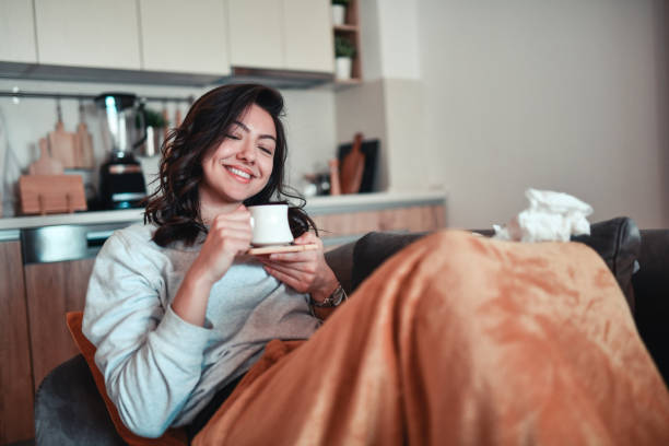 istock Smiling Female Drinking Morning Coffee In Bed While Getting Through COVID-19 With Ease 1316441727