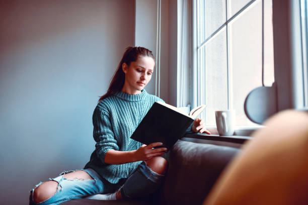 istock Home Weekend Relaxation For Cute Female With Coffee And Book 1316441896
