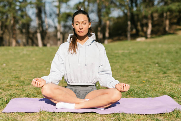istock Young woman practicing yoga outdoors 1316441955