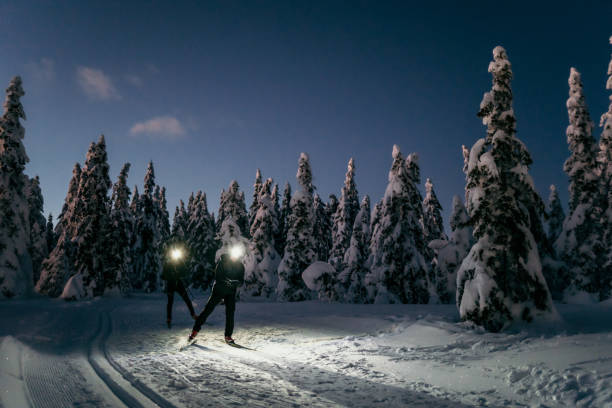 istock Two people skiing on snow at night 1316442058