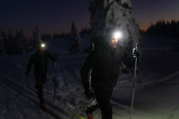 istock Two people skiing on snow at night 1316442068