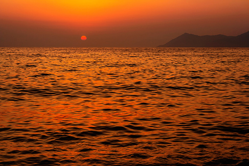 Landscape with a beautiful sunset over the sea on a summer evening