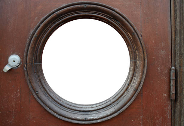 vintage wooden door with round window, door hinge and lock, with space for text stock photo