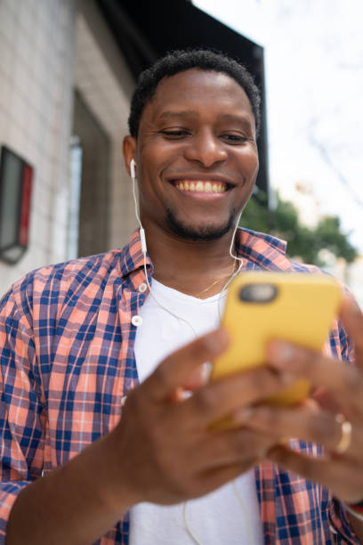 istock Man using his mobile phone on the street. 1316444551