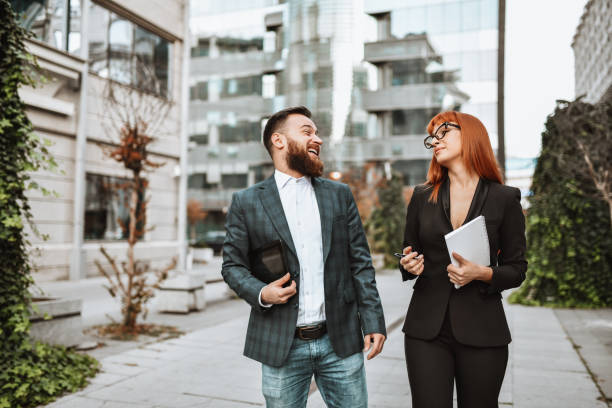 istock Smiling Business Couple Having Fun While Walking Together To Work 1316444819