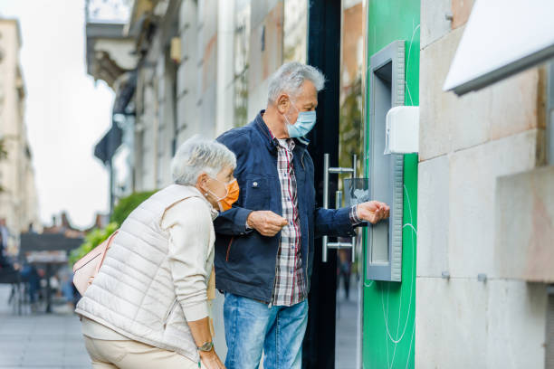 istock Senior Couple is Using ATM During a Pandemic Time. 1316444933