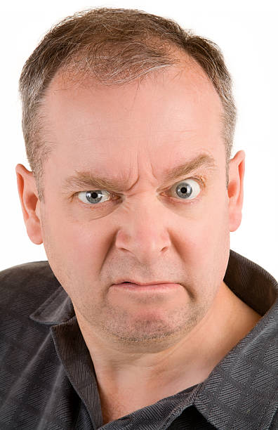 Grumpy Middle Aged Man This is a portrait of a grumpy middle aged man. derange stock pictures, royalty-free photos & images