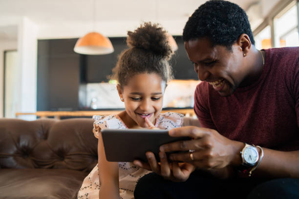 istock Father and daughter using digital tablet at home. 1316445592