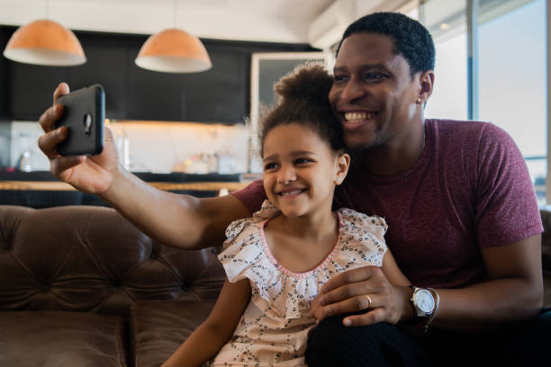 istock Daughter and father taking a selfie with phone. 1316445593