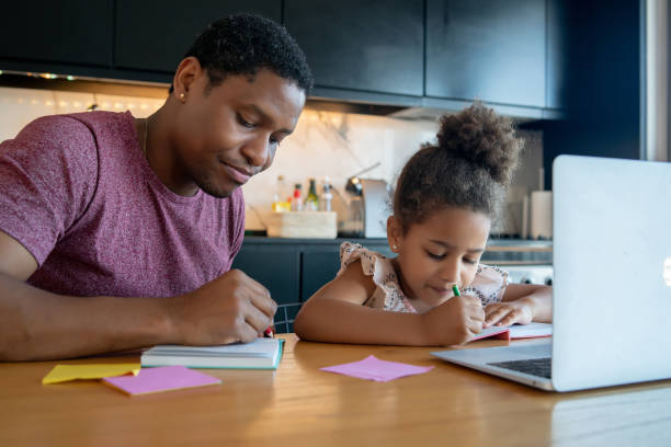 istock A father helping his daughter with homeschool. 1316445609