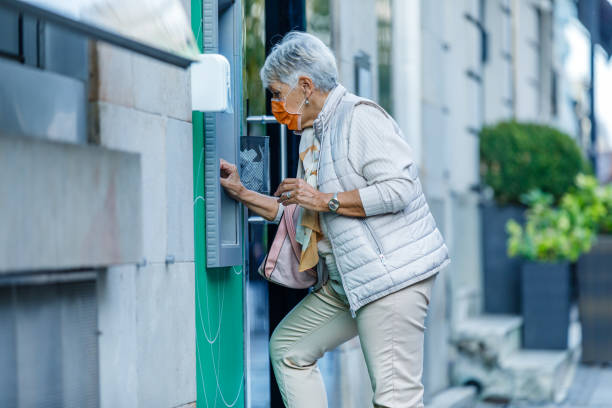 istock Senior Woman is Using ATM During a Pandemic Time. 1316445766