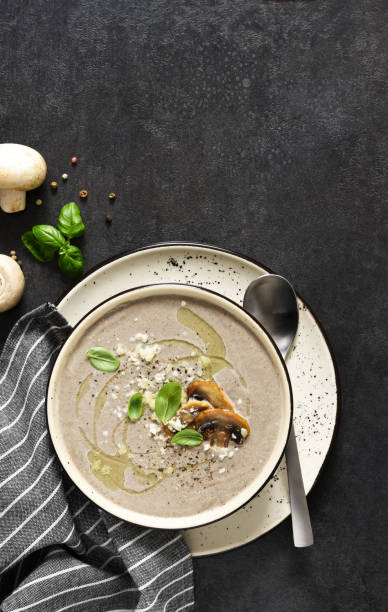 istock Soup puree with mushrooms and parmesan on a concrete kitchen table.Top view. 1316446253