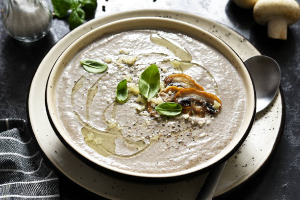 istock Soup puree with mushrooms and parmesan on a concrete kitchen table.Top view. 1316446284