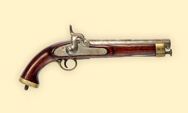 istock Old hand gun with wooden handle on beige background 1316449507