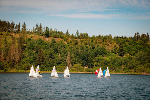 The deep blue water of the bay and the tall mountains showed off the small sailboats on a hazy day