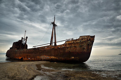 Old ship wrecked on the Greek coast and abandoned on the beach, his name was Dimitrios. Photo representing the concept of abandoned and failure