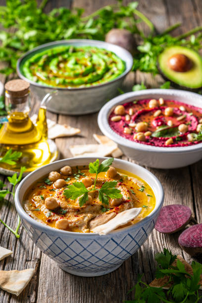 istock Hummus Three bowl of chickpeas, avocado and beetroot vegetables for dip on rustic wooden table 1316452438
