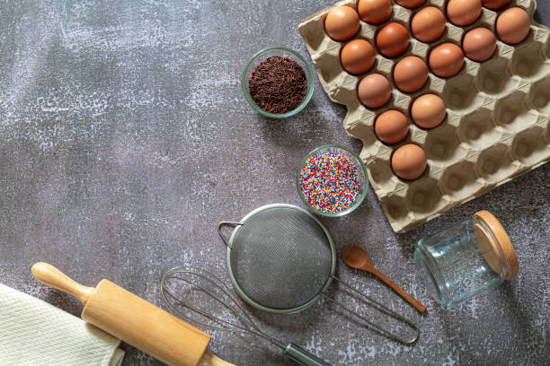 istock Cake background equipment preparation,fresh eggs and cake flour with kitchen utensils for pastries on wood background, prepare for make cake and bakery concept 1316455451