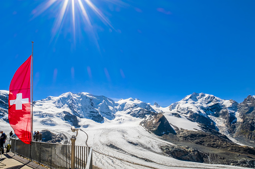 People admiring the Morteratsch glacier from the panoramic terrace at the Diavolezza mountain station, a col and ski resort above the Val Bernina in Graubuenden.