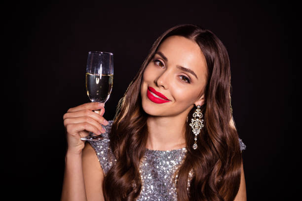 豪華な見事な若い女性の写真は、黒い色の背景に孤立したグラマー服を着てシャンパングラスを保持 - champagne celebration glass black ストックフォトと画像