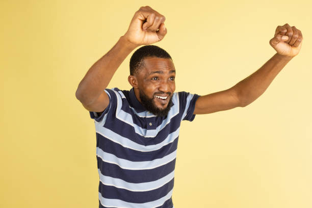 istock One African young man posing isolated over yellow studio background with copyspace for ad 1316458448