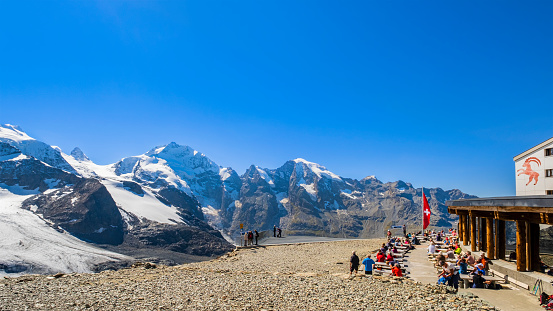 People resting at the Diavolezza mountain station, a col and ski resort above the Val Bernina in Graubuenden.