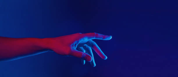 male hand touching or pointing in neon red blue lighting, web banner stock photo