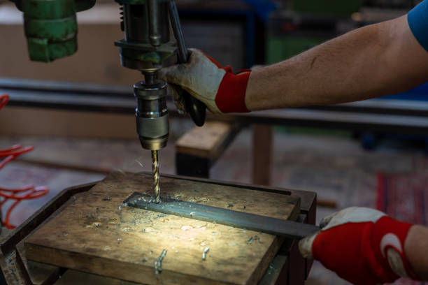 istock metal worker drilling holes in metal with a bench drill 1316461870
