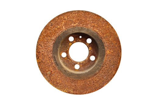 Old rusty brake disc from car isolated on white background