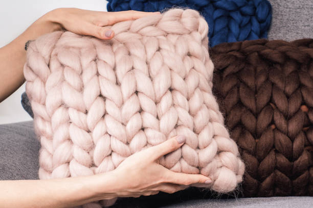 istock Knits made from thick soft yarn. Soft knitted cushions made of thick yarn. 1316462127