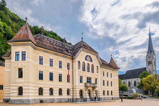 The Government building of Vaduz, dating to the early 1900s, is centrally located in Peter-Kaiser-Platz square, the government district of the capital of Liechtenstein. Cathedral in background.