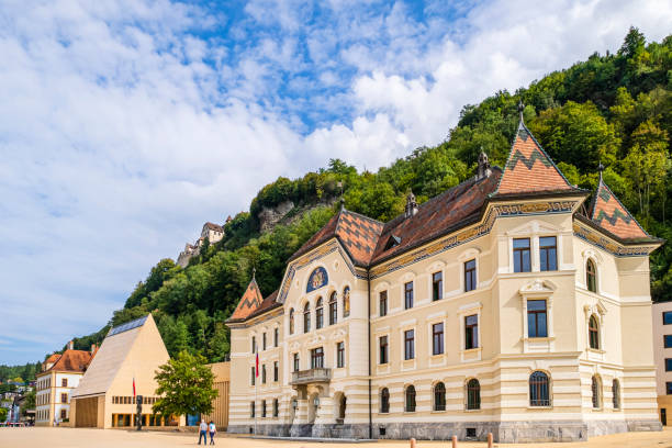 Vaduz, Liechtenstein - July 8, 2016: The Parliament building with Vaduz Castle in Liechtenstein. Principality of Liechtenstein is one of the world's smallest countries. It is located between Switzerland and Austria. its capital is Vaduz.