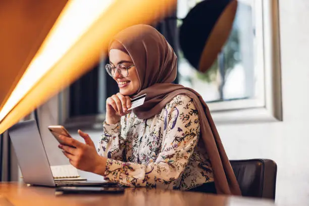 Photo of Middle Eastern Girl Shopping Online Using Credit Card