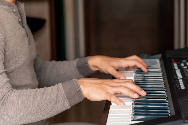 istock Close-up of hands playing piano at home 1316467629