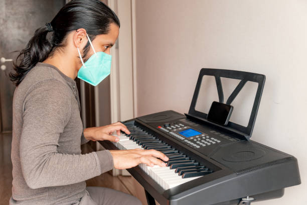 istock Young latin man playing piano at home 1316467641