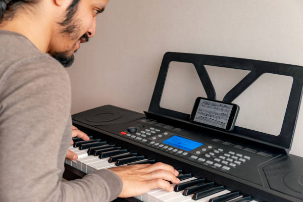 istock Young latin man playing piano at home 1316467728