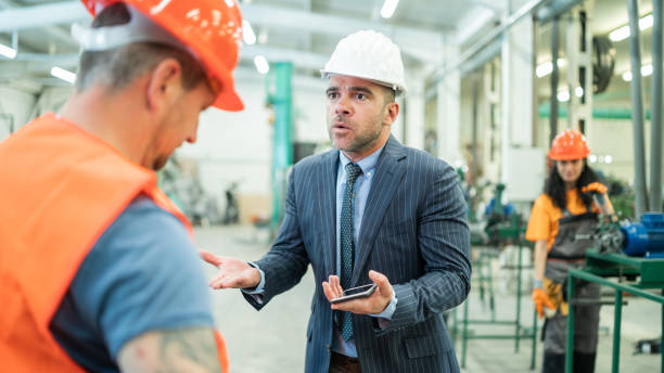 Furious male employee screaming at worker and blaming him for allowed mistake