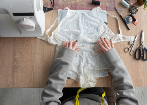 istock Flat lay, hands of a lingerie designer. Underwear making. 1316470087