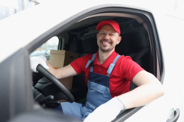 istock Smiling male courier driver driving car closeup 1316470699