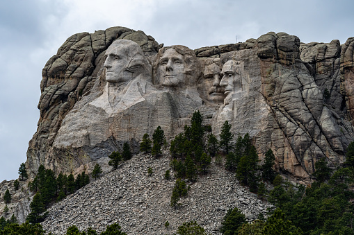 The sculptures of presidents Abraham Lincoln, George Washington, Theodore Roosevelt, and Thomas Jefferson in the mountains of the Black Hills National Forest in Custer, SD