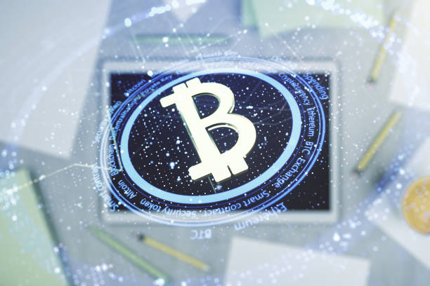 istock Double exposure of creative Bitcoin symbol and digital tablet on background, top view. Cryptocurrency concept 1316474417